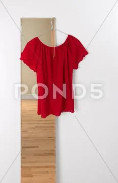 Red blouse hanging on a mirror Stock Photos