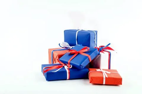 Red, blue and white gift boxes with ribbons on a white background Stock Photos