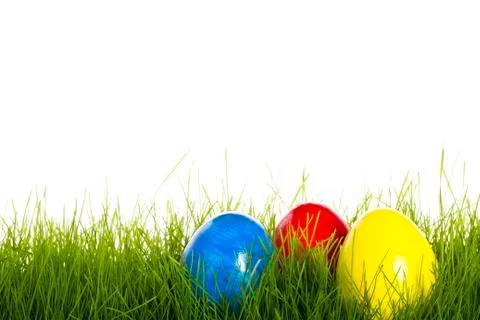 Red blue and yellow easter egg in grass Stock Photos