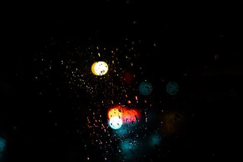 Red blue and yellow light bokeh dots on dark background which its come from.. Stock Photos