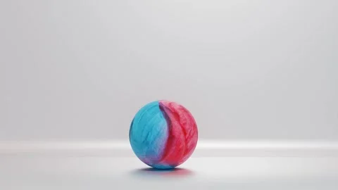 Red blue textile ball rolls from right to left on silver background. 3d render a Stock Footage 300845007