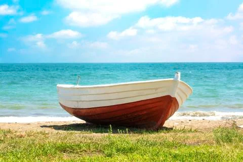 Red Boat and Clouds Stock Photos