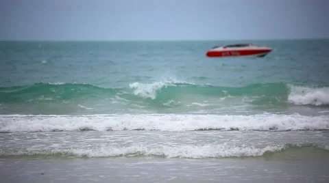 Red boat on a beach. Sea waves during cloudy weather. HD. 1920x1080 Stock Footage 44122032
