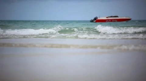 Red boat on a beach. Sea waves during cloudy weather. HD. 1920x1080 Stock Footage 44122504