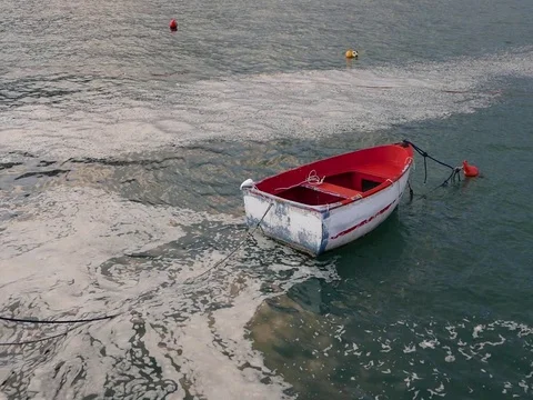 Red boat floating Stock Footage 73268143