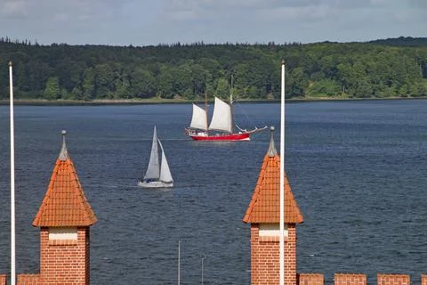 A red bodied sailing ship sails along Flensburg Fjord in Schleswig Holstein r Stock Photos