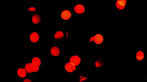 Red bokeh of intermittent lights on a black background. Stock Footage 99873959