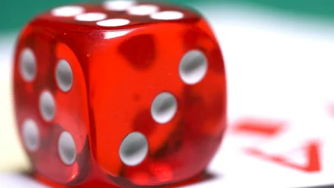 Red bones on the gaming table with dollars and chips to play through the lens Stock Footage 86455349