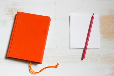 Red book and notepad with coloured pencil Stock Photos