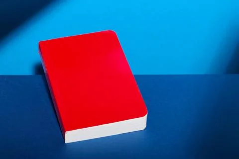Red book on a blue table Stock Photos