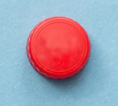 Red bottle cap on blue background Stock Photos