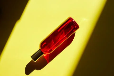 Red bottle with shadow effect isolated on a yellow background. The concept of Stock Photos