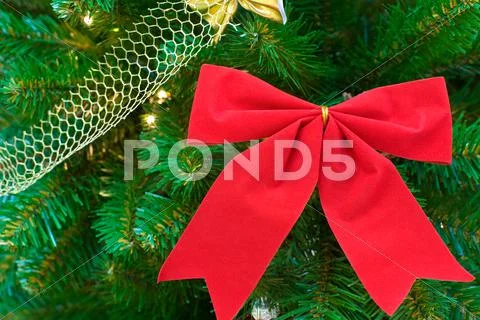 Red bow on christmas tree Stock Photos