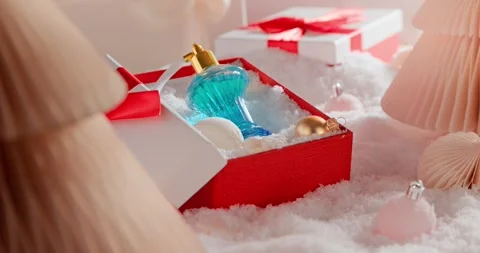 A red bow decorates the perfume Christmas gift. Stock Footage 345458734