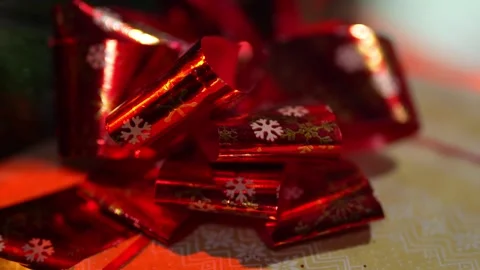 A red bow on a gift under the Christmas tree Stock Footage 325732195