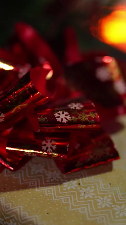 A red bow on a gift under the Christmas tree Stock Footage 325732199