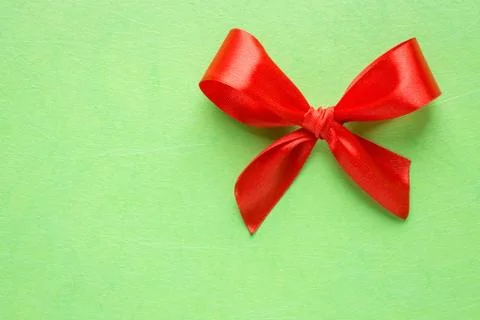 Red bow on green texture Stock-Fotos