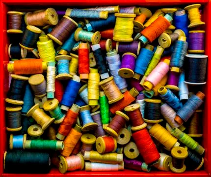 Red box with colored threads for sewing Stock Photos
