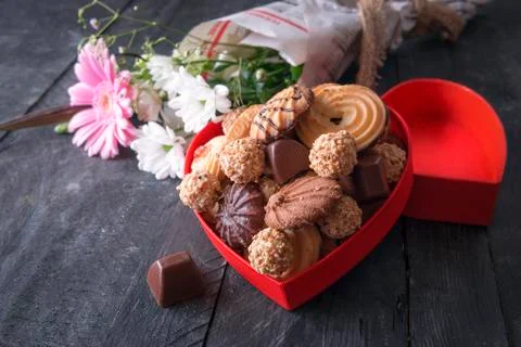 Red box full of sweets and flowers Stock Photos