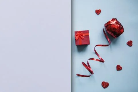 Red box with a gift on a festive background. Stock Photos