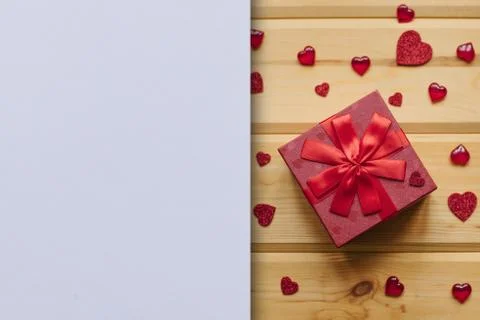 Red box with a gift on a festive background. Stock Photos