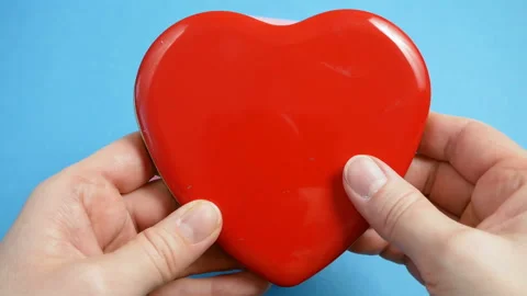 Red box with heart with bow in hands, sweet valentine's day Stock Footage 147441003