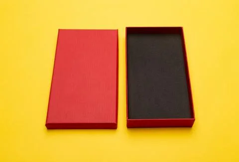 Red box product packaging isolated on yellow background Stock Photos