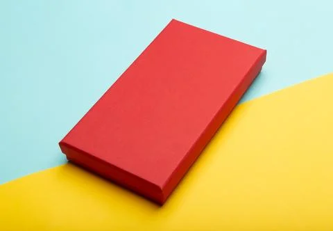 Red box product packaging isolated on yellow half blue background Stock Photos