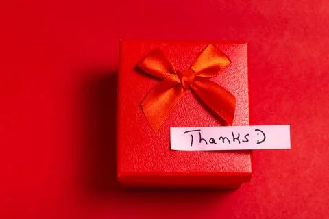A red box with a red bow on top and a white note that says "Thanks" Stock Photos
