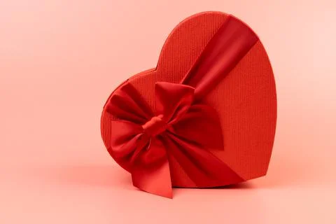 Red box in shape of heart. Gift box for Valentine's Day. Isolated on pink bac Stock Photos