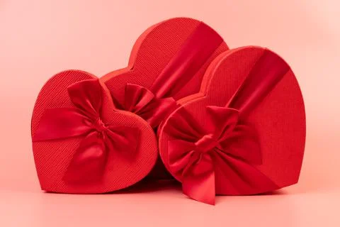 Red box in shape of heart. Gift box for Valentine's Day. Isolated on pink bac Stock Photos
