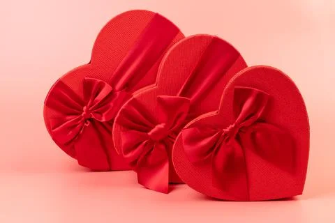 Red box in shape of heart. Gift box for Valentine's Day. Isolated on pink bac Stock Photos