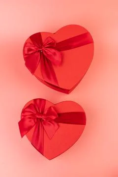 Red box in shape of heart. Gift box for Valentine's Day. Isolated on pink bac Stock Photos