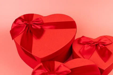 Red box in shape of heart. Gift box for Valentine's Day. Isolated on pink bac Stock Photos