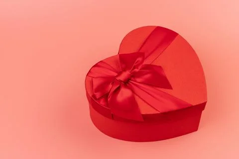Red box in shape of heart. Gift box for Valentine's Day. Isolated on pink bac Stock Photos