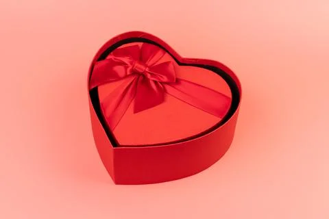 Red box in shape of heart. Gift box for Valentine's Day. Isolated on pink bac Stock Photos