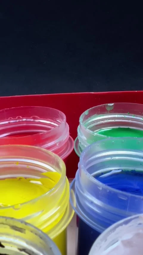 A red box with six different colored paint jars inside Stock Footage 318122095