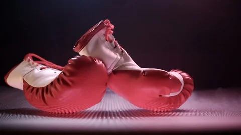 Red Boxing Gloves Falling On The Abstract Surface. Stock Footage 124452582