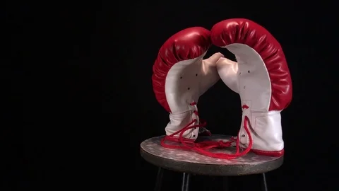 Red boxing gloves rotating on round stool. Stock Footage 73750546