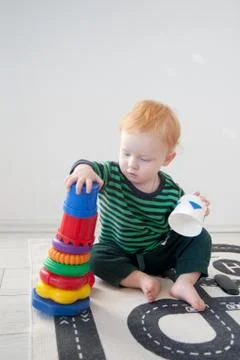 Red boy playing with a pyramid Stock Photos