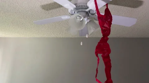 Red Bra slowly rotates on a White Ceiling Fan -HD Stock Footage 131365582