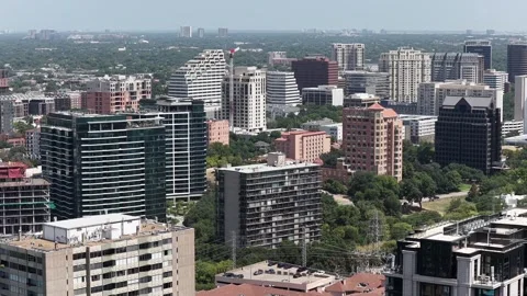 Red brick and glass mid-rise condominiums across a Dallas district aerial drone Stock Footage 342492713
