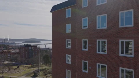 Red brick apartment building with harbor view in Sundsvall Sweden aerial view Vídeo Stock 333519786