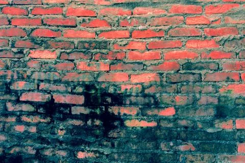Red brick background: closeup of an old uneven brick wall. Stock Photos