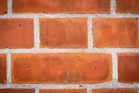 Red brick background closeup pattern with white grout lines. Stock Photos