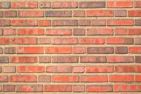 Red brick background with a thick layer of cement, a fragment of a brick wall Stock Photos