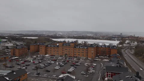 Red brick barracks and snowy parking lot in Jonkoping Sweden aerial view Vídeo Stock 330777716