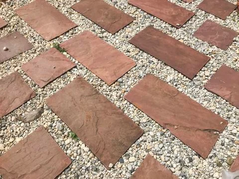 Red brick block ground in perspective Inserted with small stones along the gr Stock Photos
