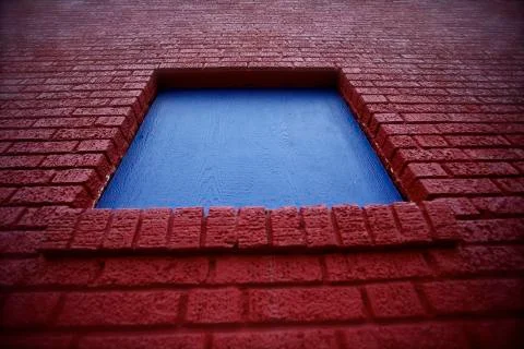 Red brick, blue window Stock Photos
