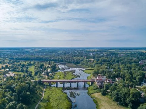 Red brick bridge over Venta river in Kuldiga, Latvia. Stock Photos